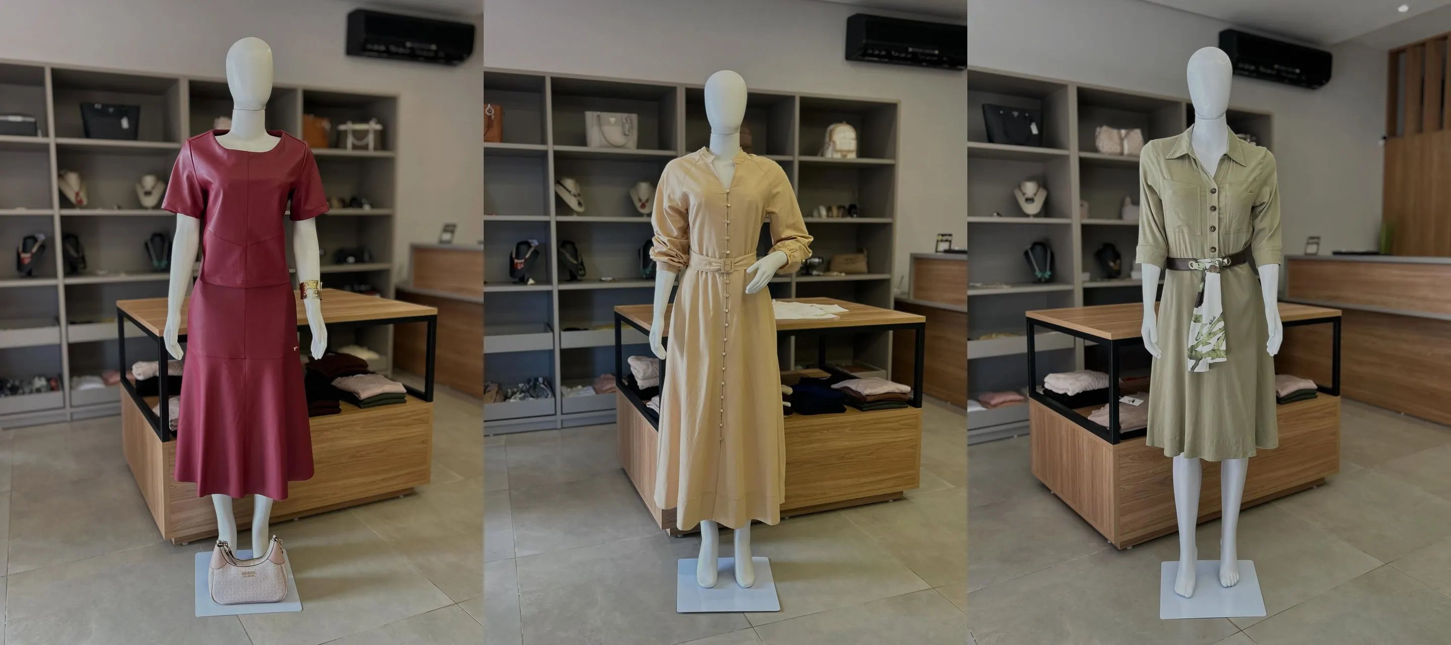 Três manequins vestidos dentro da loja Veiga's Elegance: conjunto vinho, vestido longo dourado e vestido verde-oliva